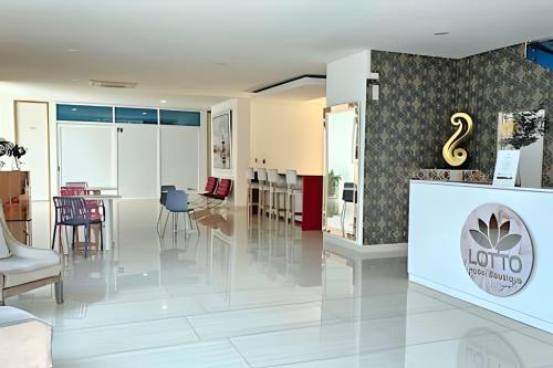 a lobby of a hotel with tables and chairs at Hotel Lotto Boutique in Cali