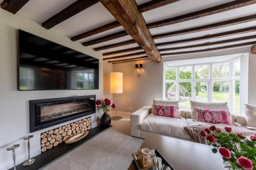 a living room with a fireplace and a couch at Hall O'Coole in Nantwich