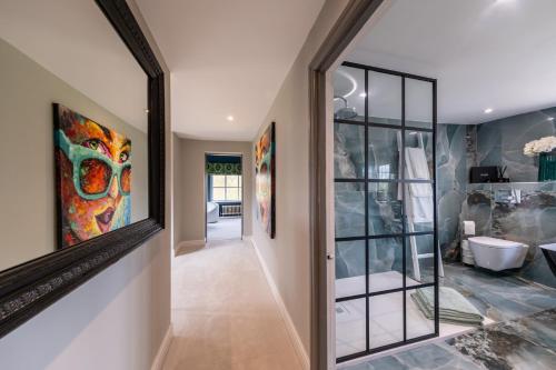 a hallway of a home with a large mirror at Hall O'Coole in Nantwich