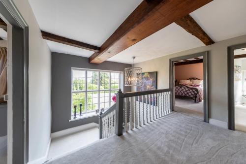 a home hallway with a staircase and a bedroom at Hall O'Coole in Nantwich