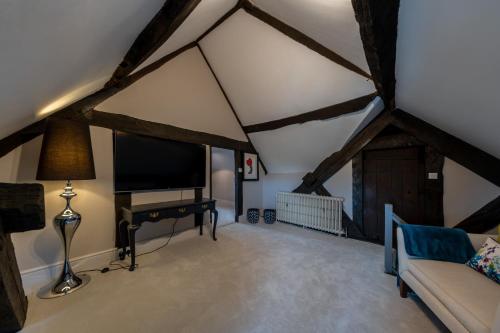 a living room with a tv and a couch at Hall O'Coole in Nantwich