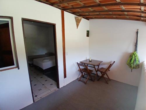 a room with a table and a room with a bed at Pousada Unidos in Jijoca de Jericoacoara