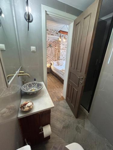 a bathroom with a sink and a toilet and a mirror at Filipa Gardens in Limenas