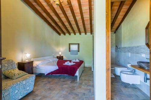 a bedroom with a bed and a bath tub at Podere La Querciola in Guardistallo