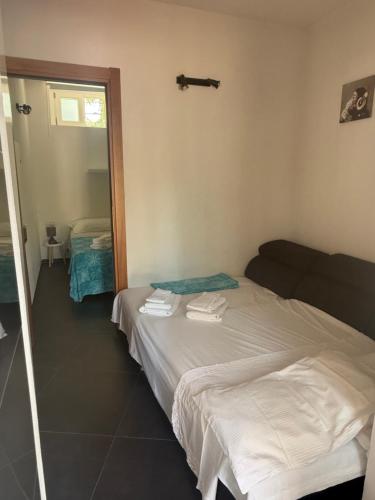 a hotel room with a bed and a mirror at Tosk House in Peschici