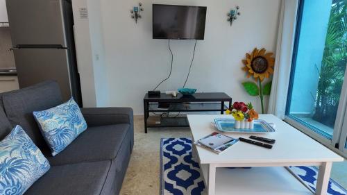 a living room with a couch and a table at La Fenice Beachfront Apartment in Las Terrenas