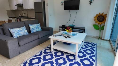 a living room with a couch and a coffee table at La Fenice Beachfront Apartment in Las Terrenas