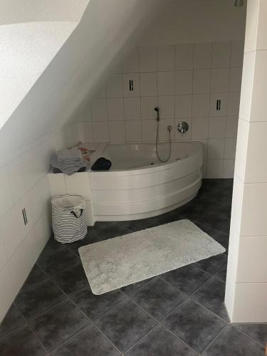 a bathroom with a bath tub in a attic at Zentral im Grünen in Dortmund