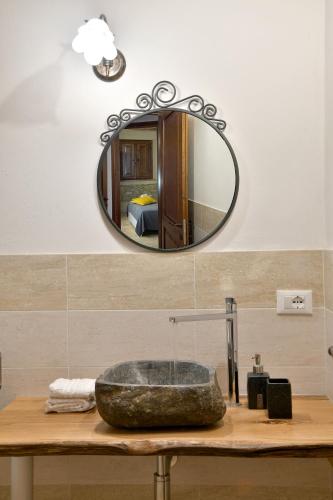 a bathroom with a sink and a mirror at Podere La Querciola in Guardistallo