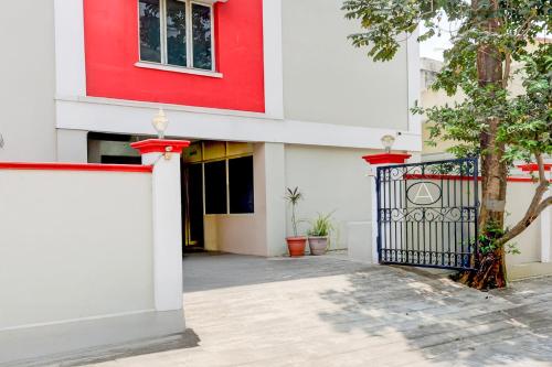 a red and white building with a gate at Super Collection O Bhanugudi Junction Kakinada Formerly Stay Inn Luxury in Kākināda