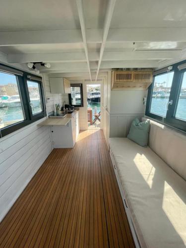 an interior of a boat with a couch in the middle at Houseboat BlueSeaDream Dolphin Casetta Galleggiante in Alghero