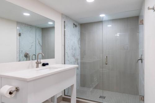 a bathroom with a sink and a shower at The Fold Hotels Orlando in Orlando