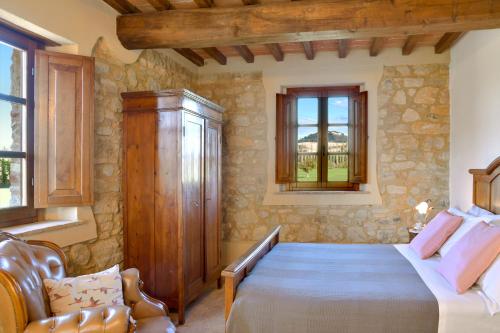 a bedroom with a large bed and a window at Podere La Querciola in Guardistallo