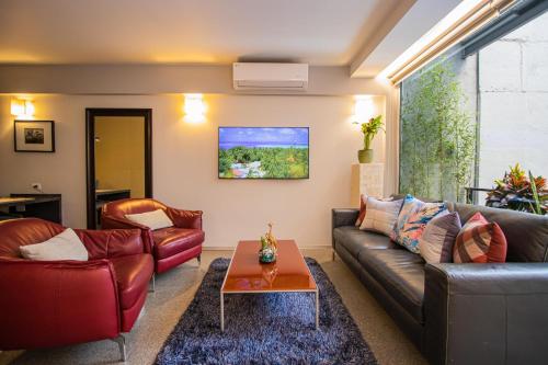a living room with a couch and a table at Masaryk 123 Executive Luxury Apartments in Polanco in Mexico City