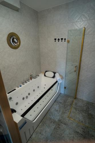 a bathroom with a shower and a bath tub at Apartamenty pod Gromadzyniem Górski Relaks in Ustrzyki Dolne