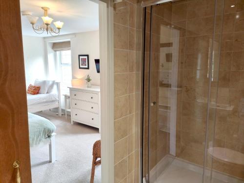 a bathroom with a shower with a glass door at Bush Nook House in Brampton