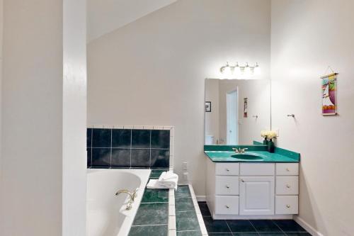a bathroom with a tub and a sink at Bayside View in Ocean City