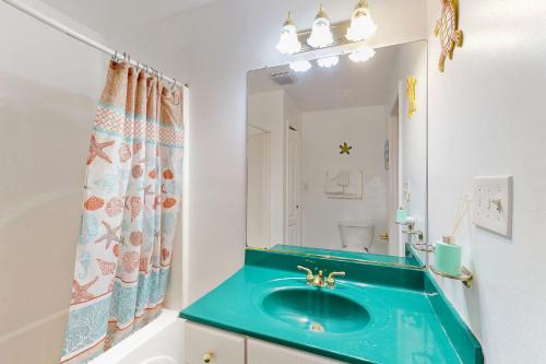 a bathroom with a blue sink and a mirror at Bayside View in Ocean City