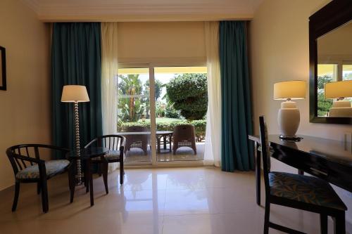 a living room with a table and chairs and a window at Sierra Sharm El Sheikh in Sharm El Sheikh