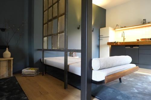 a bedroom with a bunk bed and a bench in it at Design Boutique Apartments Weissensee in Weissensee