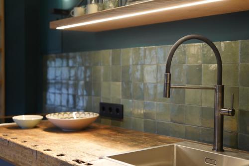 a kitchen with a sink and two bowls on a counter at Design Boutique Apartments Weissensee in Weissensee