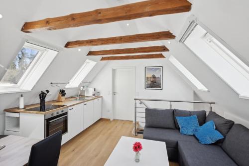 a kitchen and living room with a couch and a table at Hof Heideglück in Schneverdingen