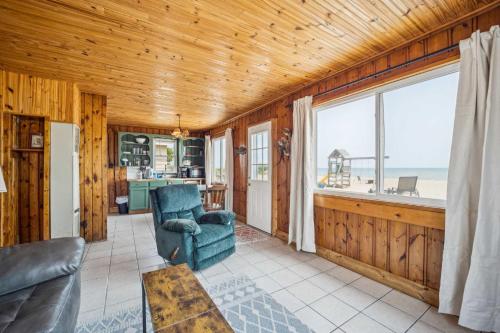 a living room with a couch and a chair at Lake Views with Big Windows & Bath in Oscoda