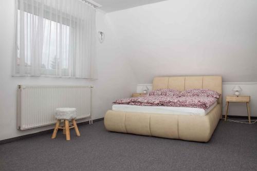 a bedroom with a large bed and two windows at Holiday home in Balatonmariafürdo 38170 in Balatonmáriafürdő