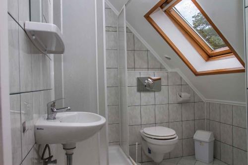 a bathroom with a sink toilet and a skylight at Holiday home in Balatonmariafürdo 38170 in Balatonmáriafürdő