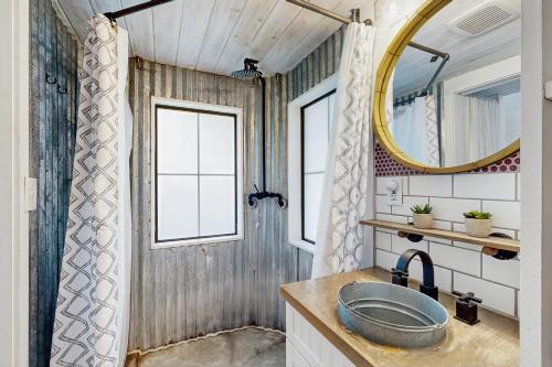a bathroom with a sink and a mirror at Chimney Rock Tiny Home in Canyon Lake