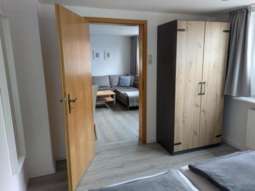 a door leading to a living room with a couch at Haus Windjammer in Neuharlingersiel