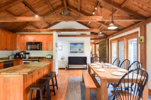 a dining room with a long table and chairs at Steps to Freshwater Beach Kayaks Sauna in Brewster