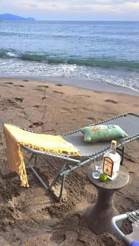 a chair and a table on the beach at Studio bord de mer in Schœlcher