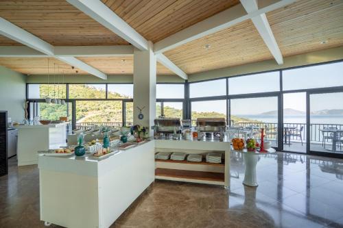 a kitchen with white counters and large windows at Med-Inn Hotel in Gulluk