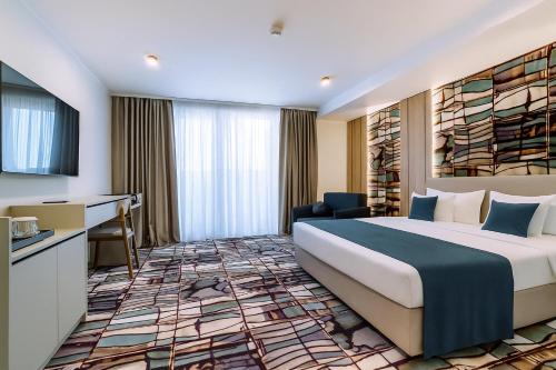 Postel nebo postele na pokoji v ubytování ARIS Boutique Hotel & SPA