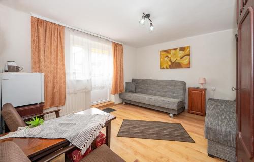 a living room with a couch and a table at Noclegi Paradise in Darłówko