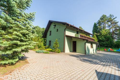 an external view of a house with a brick driveway at Chata Bella in Smižany