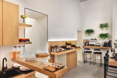 a kitchen with a counter with some food on it at Fortunella Suites Luxury in Portici