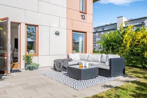 a patio with a couch and a coffee table at Appartment close to Hyllie in Klagshamn