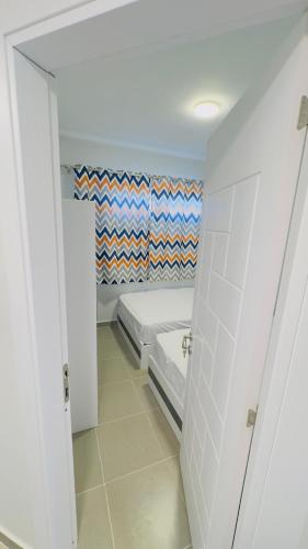 a small bedroom with a bed in a room at Porto Matrouh Unique Chalet 81003 in Marsa Matruh