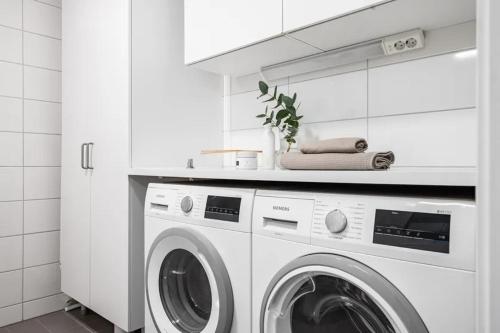a white laundry room with a washing machine at Appartment close to Hyllie in Klagshamn
