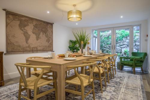 a dining room with a long table and chairs at Moss Crag in Penrith
