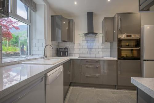 a kitchen with stainless steel appliances and a window at Moss Crag in Penrith