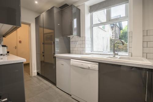 a kitchen with a sink and a window at Moss Crag in Penrith