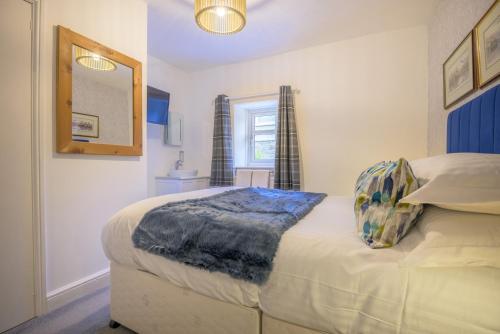 a bedroom with a bed and a mirror at Moss Crag in Penrith