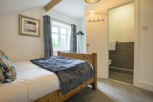 a bedroom with a bed and a shower at Moss Crag in Penrith