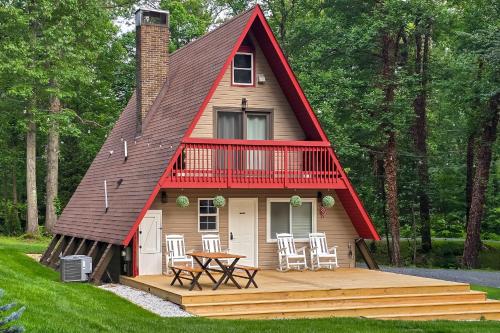 a tiny house with a red roof and a deck at Hot Tub, Fire Pit and Patio A-Frame Stafford Cabin in Stafford