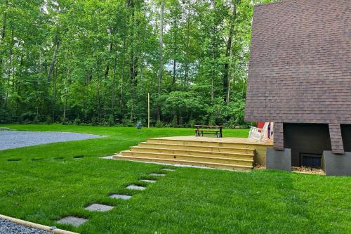 a park with a bench and stairs in the grass at Hot Tub, Fire Pit and Patio A-Frame Stafford Cabin in Stafford