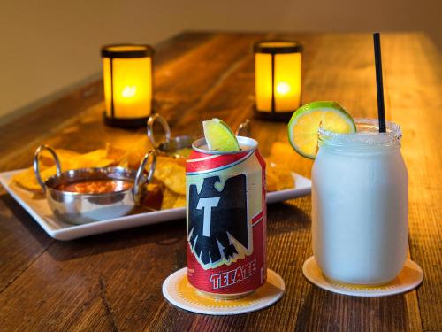 a table with a drink and a soda can on it at The Whitehall Houston in Houston