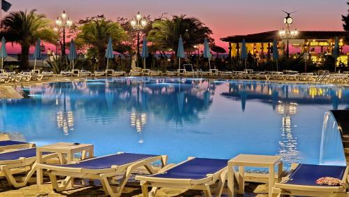 a large pool with lounge chairs and a resort at Dreamland Oasis 1 Studio in Chakvi